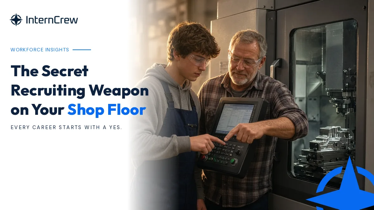 A high school student programs a CNC mill on a shop floor while a veteran machinist mentor points at the control screen.
